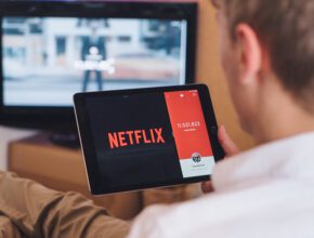 Netflix A man watching Netflix on a tablet