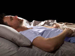 Man with insomnia lays awake in his bed in the middle of the night Let's Talk: Insomnia