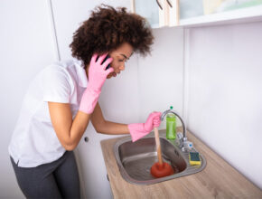 woman with a clogged sink How to prevent a clogged drainage system problem?